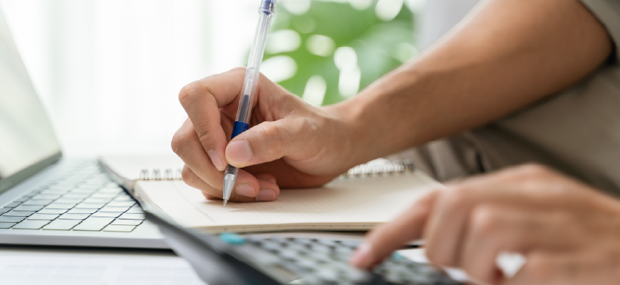 Person using calculator and figuring out commissions