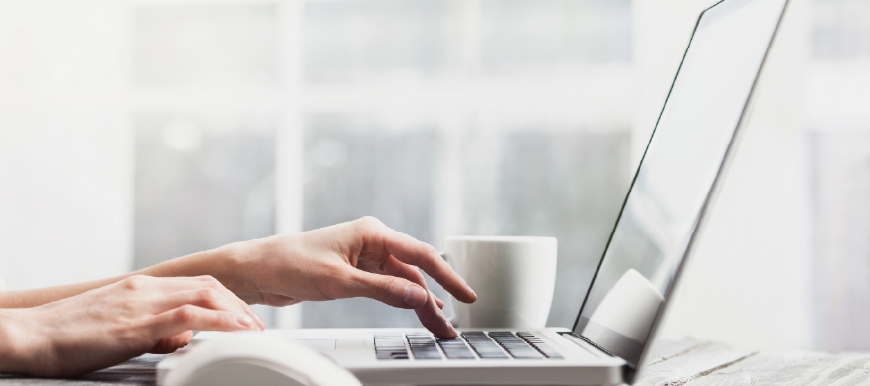 Business professional typing on computer