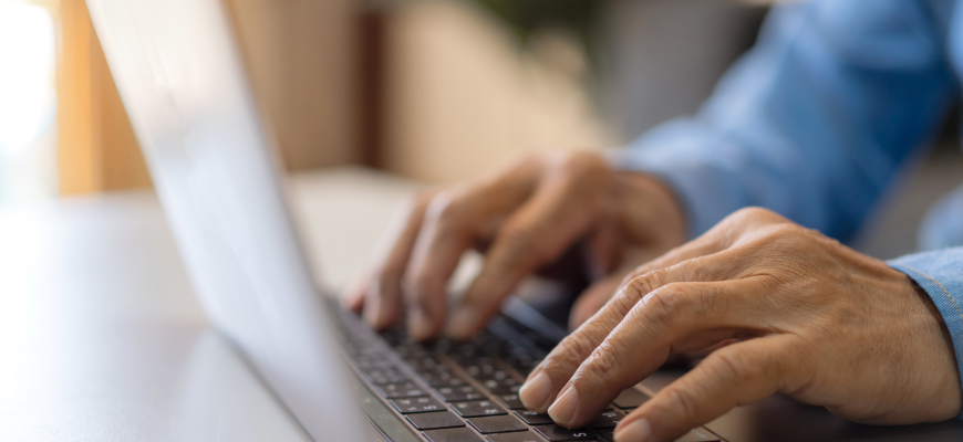 Man typing on laptop