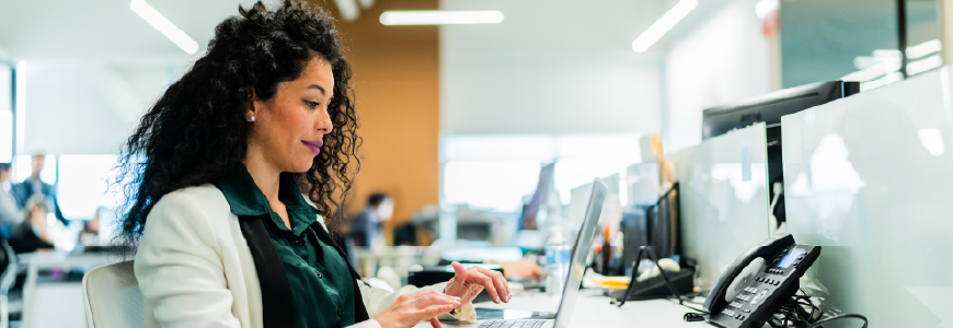 Insurance agent in office working on laptop