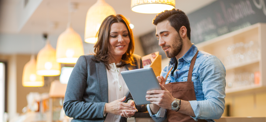 An insurance agent meeting with a business owner about employee benefits