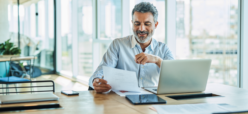 Agent reviewing paperwork at desk