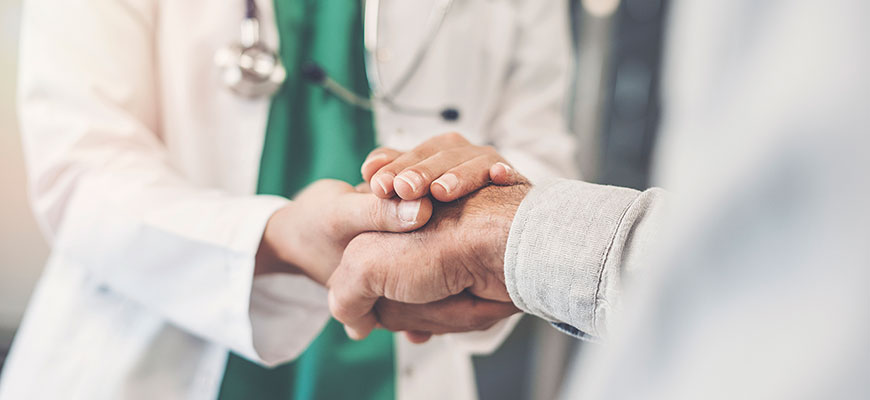 A warm handshake between a doctor and patient