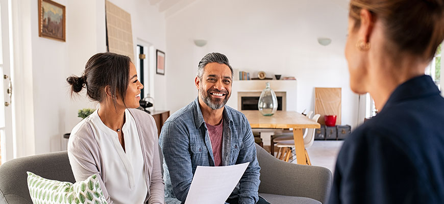 Insurance agent meeting with clients at their house