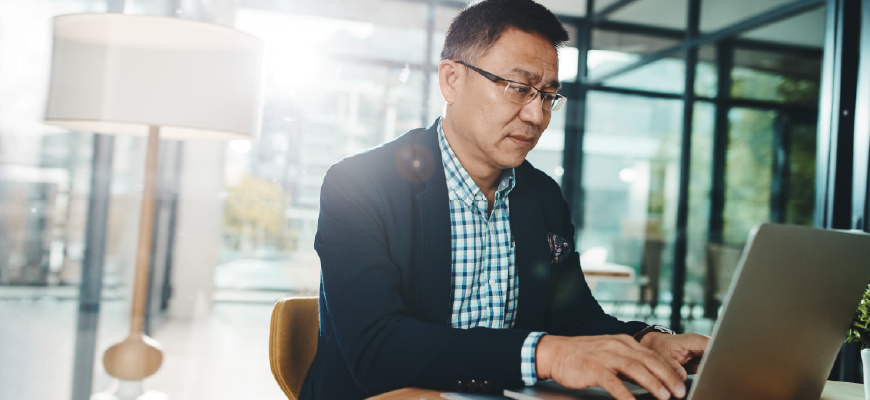 Insurance agent typing on laptop