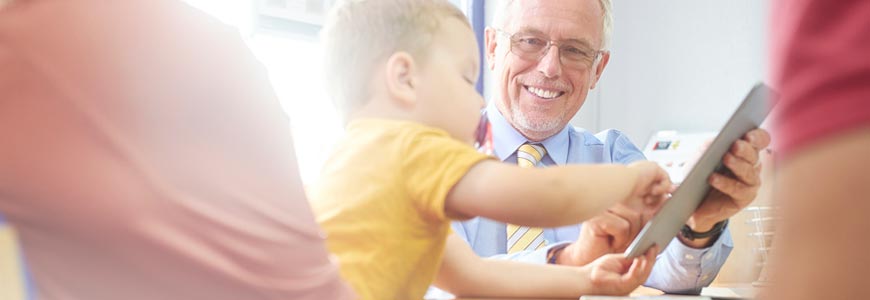 Insurance agent showing life insurance options with a kid playing on his ipad