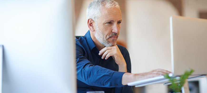 Insurance agent working on two computers