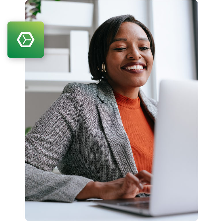 Woman smiling while working on computer