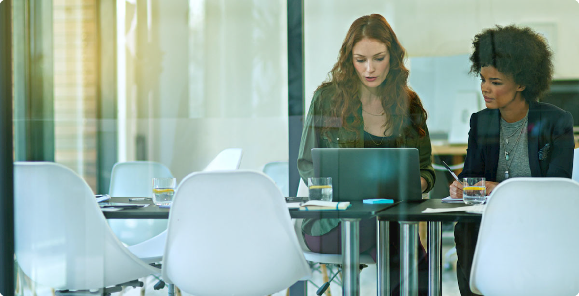 Two female employees working in office